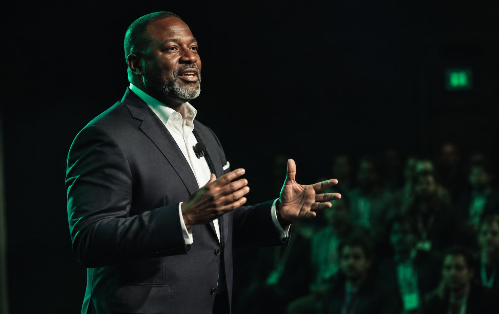 Jonathan Mondesir speaking on stage